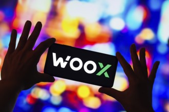 In this photo illustration, the WOO X logo seen displayed on a smartphone