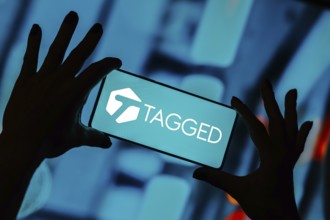 In this photo illustration, the Tagged logo is displayed on a smartphone screen
