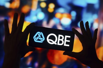 In this photo illustration, the QBE Insurance Group logo is displayed on a smartphone mobile screen