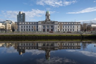 Cork city hall building reflected on river lee. Ireland Europe