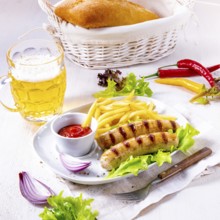 Grilled bratwurst with chips and cold beer