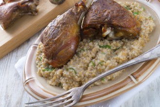 Roasted goose thighs with grits