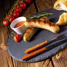 Rustic bratwurst with ketchup and fresh rolls