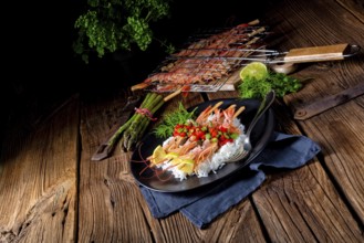 Grilled red argentine shrimps with red salsa and green asparagus