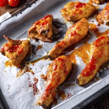 Rustic backed chicken wings, legs on baking tray