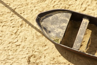 Aerial view and top view of a sandy beach with an old tin rowing boat