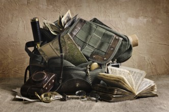 Still life with an old backpack and travel accessories