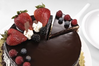 Chocolate cake with strawberries on a table