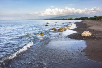 An image of a dark sand beach in northern Bali Indonesia