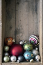 Christmas decoration glass balls in a wooden box background