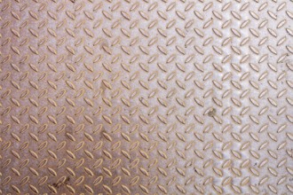 An image of a rusty diamond metal plate background