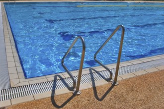 Pool with pure transparent water and hand-rail of descent