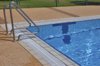 Pool with pure transparent water and hand-rail of descent