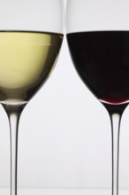 Wineglass with red and white wine on a white background