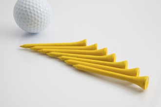 The yellow wooden golf tees