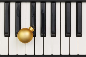 Top view close up shot of piano keyboard and Christmas decoration. Flat Lay Image