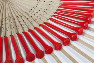 Typical Japanese hand fan made of bamboo and golf equipments