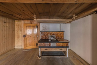 The living room with tiled stove in a house built around 1750 that has since been demolished.