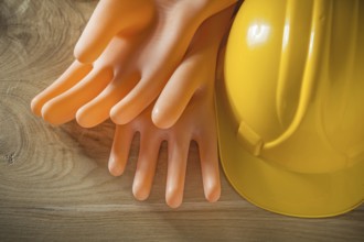 Safety building helmet electricians gloves on wood board