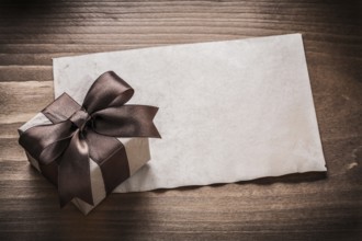 Giftbox paper on vintage wood board holiday concept