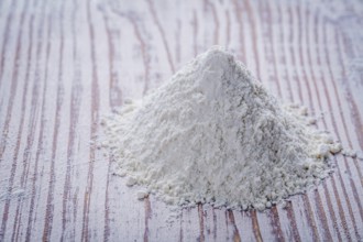 White flour on wooden board food and drink concept