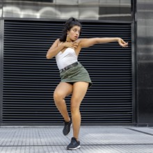 Stylish young woman celebrating through dance