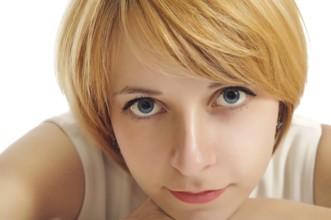 Close-up portrait of a smiling student girl with blue eyes and yellow hair
