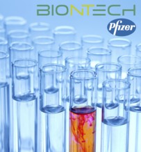 A single syringe, corona vaccine from Biontech and Pfizer, logo, test tubes, laboratory examination