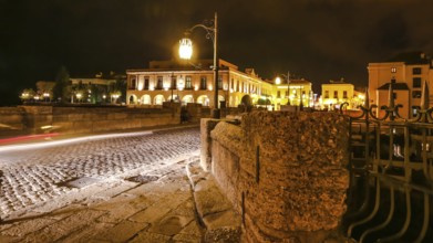 Night time on the historic landmark New Bridge Puente Nuevo of Ronda town in Spain. with running