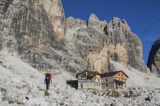 Tourist with hiking backpacks in mountain hike on summer day. Man traveler hiking in beautiful
