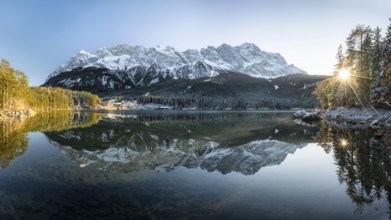 Lake Eibsee Panorama with mountain zugspitze reflection in winter with snow at sunset