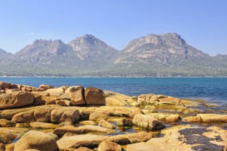 The Hazards mountain ranges in the Freycinet National Park photographed from Coles Bay, Tasmania,