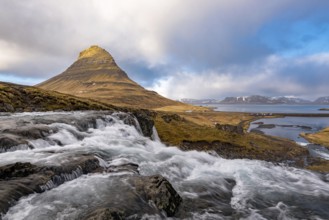 The Kirkjufell mountain and the kirkjufellfoss waterfall at grundarfjordur at Snæfellsnes peninsula