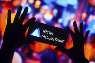 In this photo illustration, the Iron Mountain Incorporated logo is displayed on a smartphone mobile