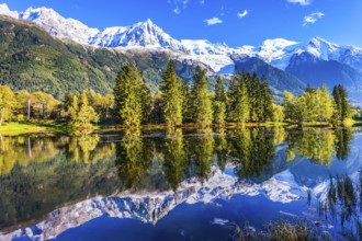 Snowy peaks of the Alps are beautifully reflected in the lake. Concept of active and ecotourism.