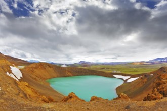 Summer in Iceland. Picturesque lake in the crater of an extinct volcano. Lake water bright green