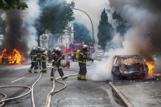 Fire brigade extinguishes burning cars on the Elbchaussee in Hamburg after the riots at the G20