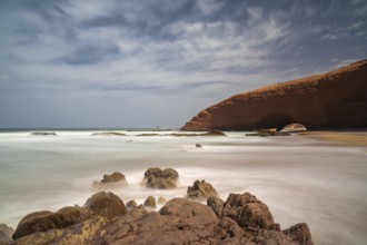 A long exposure view of the beach and rock arch at Legzira on the Atlantic Coast of Morroco