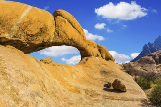 Stone arch of Spitzkoppe. Concept of extreme and ecological tourism. Natural group of smooth bald