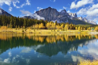 The Canadian Rockies. The city of Canmore in Banff Park. Bright autumn forest is reflected in the