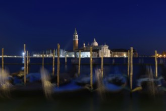 Church of San Giorgio Maggiore with gondolas at night, Venice, Italy
