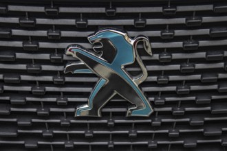WETZLAR, Germany 2022-04-23: Peugeot logo closeup on a car grill. Peugeot as car manufacturer was