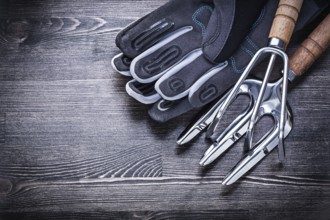Rake trowel fork protective gloves on wooden board agriculture concept