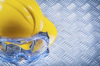 Safety spectacles building helmet on corrugated metal plate top view construction concept