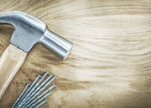 Claw hammer stainless nails on wooden board building concept
