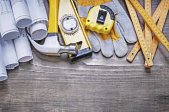 Pine wooden vintage board with construction plans and set of building objects maintenance concept