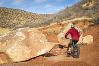 Riding a fat bike on mountain desert trail in Red Mountain Open Space in northern Colorado, late