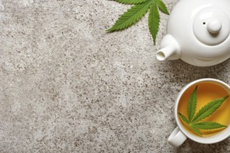 Hemp herbal tea and leaves on gray background. Calming drink concept