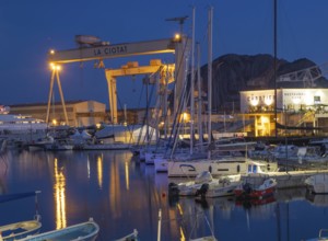 The famous harbour of La Ciotat, France, with fishing and sailing boats, in front of the industrial