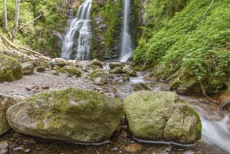 Beautiful fresh mountain waterfall in a wild and isolated valley in springtime. France